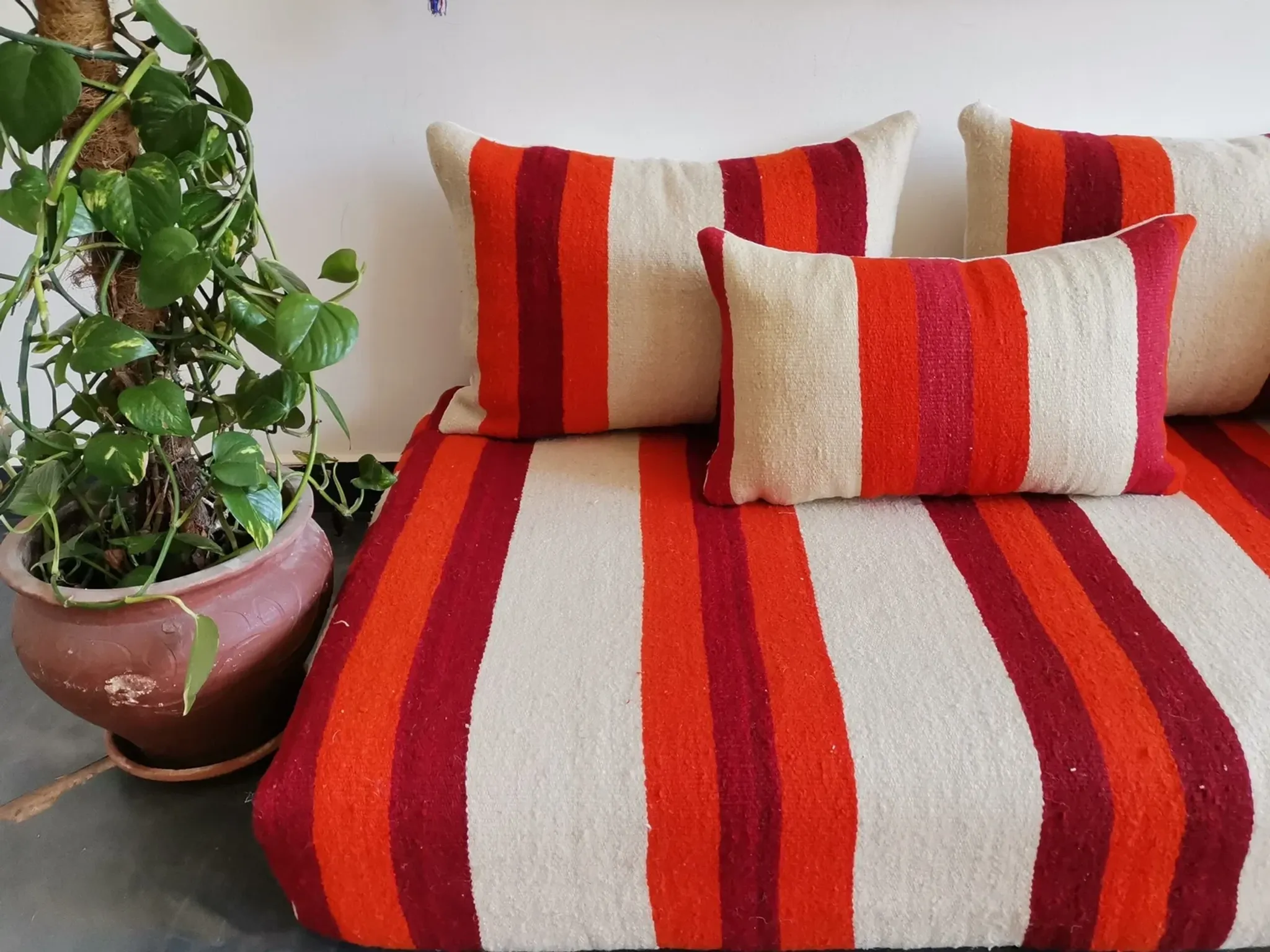 Set of covers for cream and red Moroccan floor sofa.
