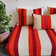 Set of covers for cream and red Moroccan floor sofa.