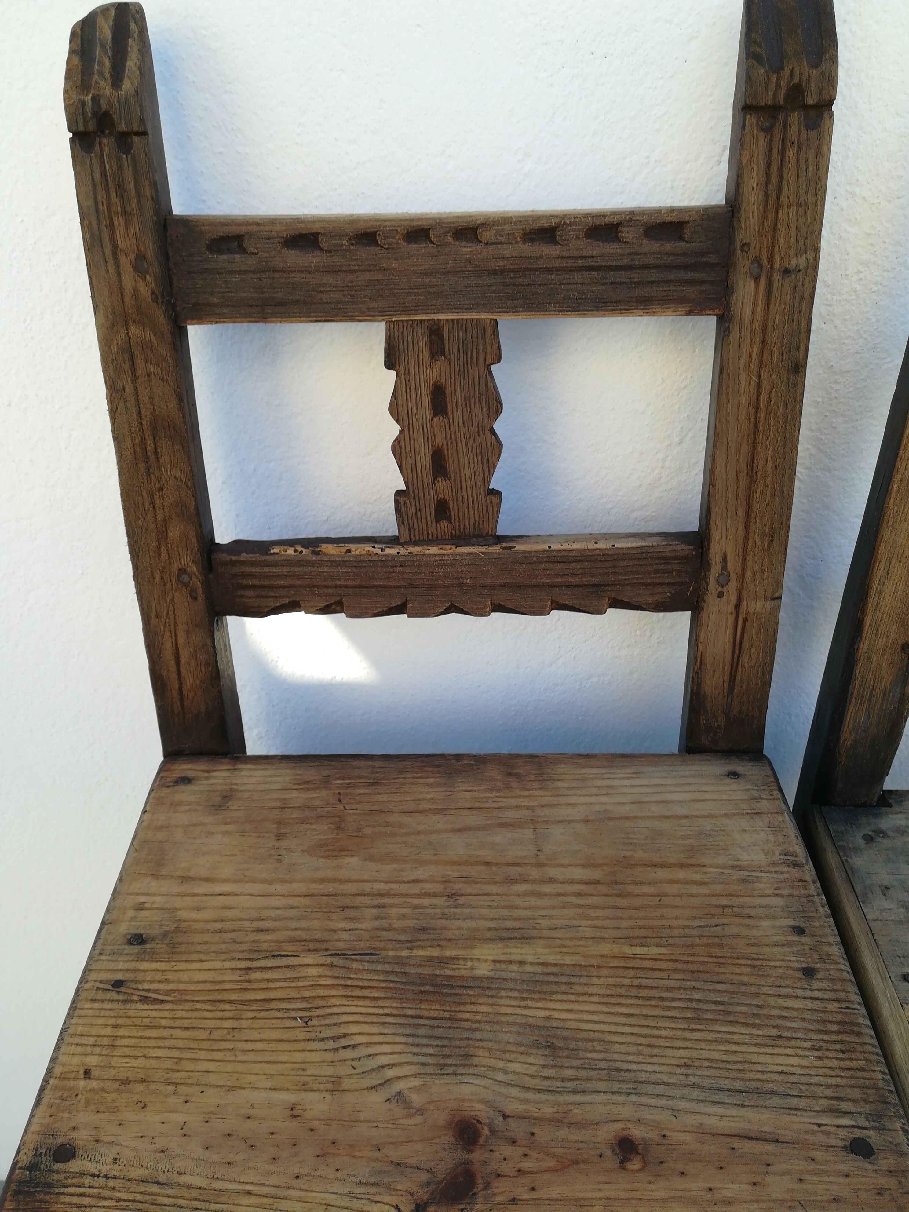 Pair of ethnic crude wooden chairs