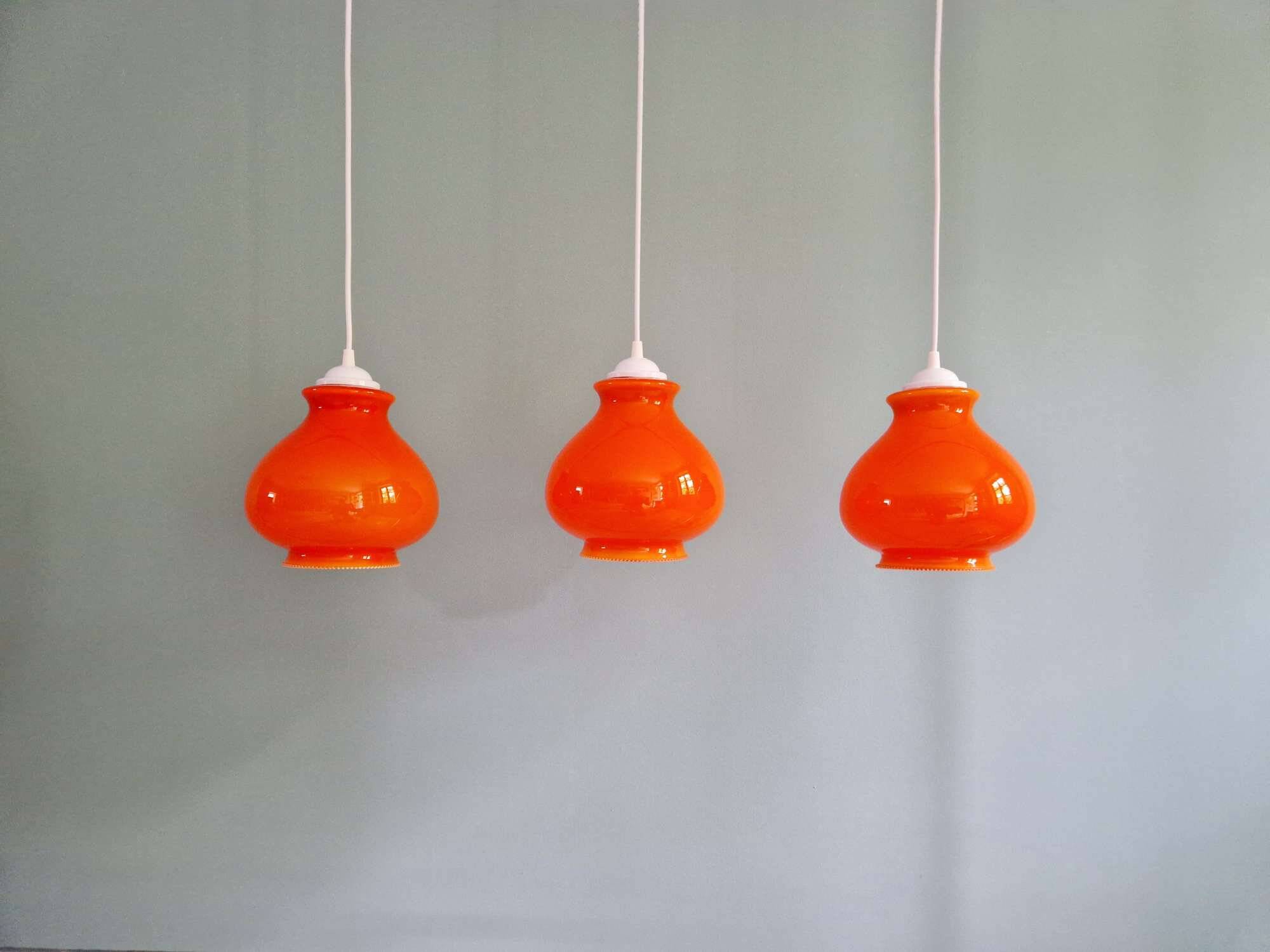 Trio of vintage orange opaline pendant lights, 1960-70