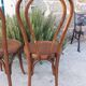 pair of round wooden chairs with a pattern on the seat
