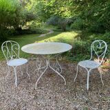 Part of a white lacquered wrought iron garden furniture set
