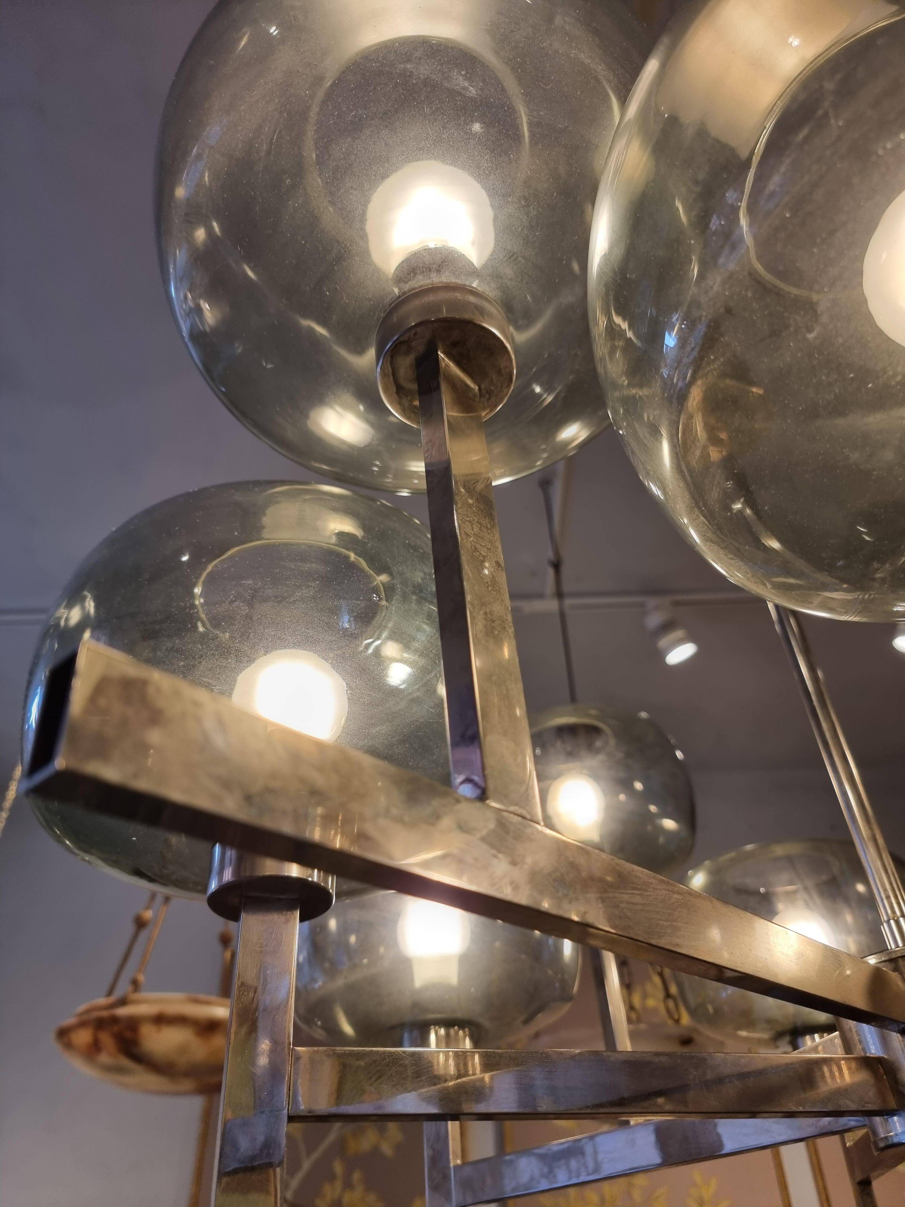 Timeless modern Scandinavian / mid-century chandelier in chrome and smoked glass.