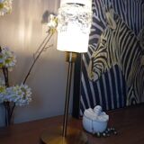Table lamp with gold metal base and cylindrical textured glass shade