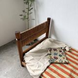 Brutalist style bed with chain and straw