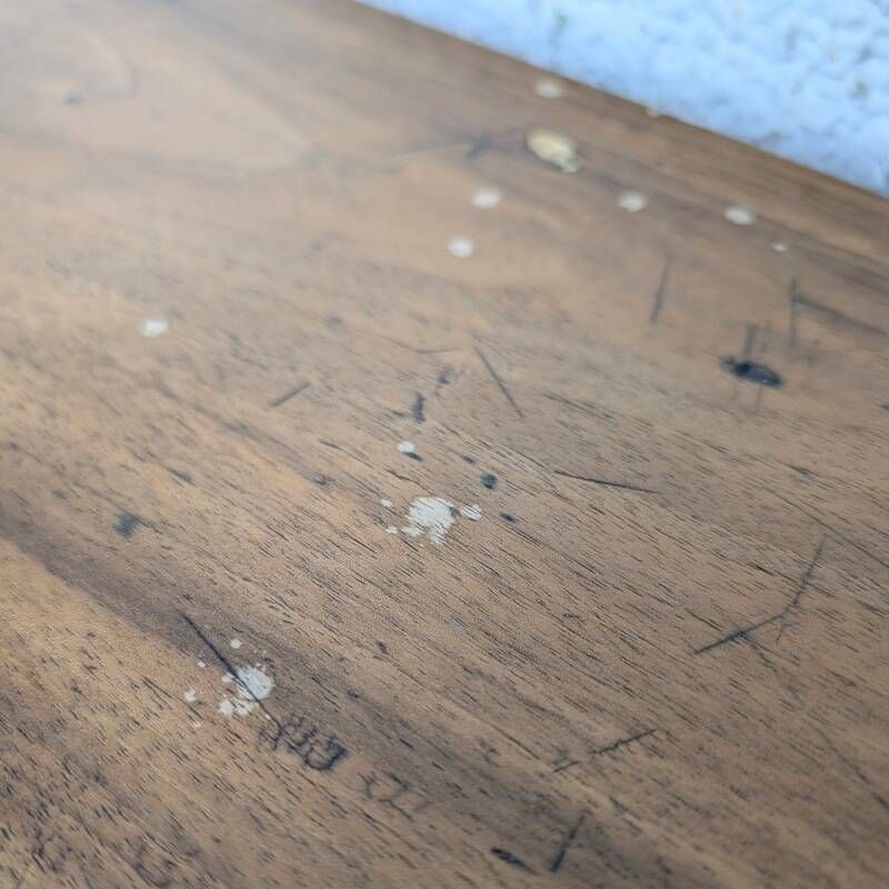 Antique wooden drop-leaf table with turned legs.