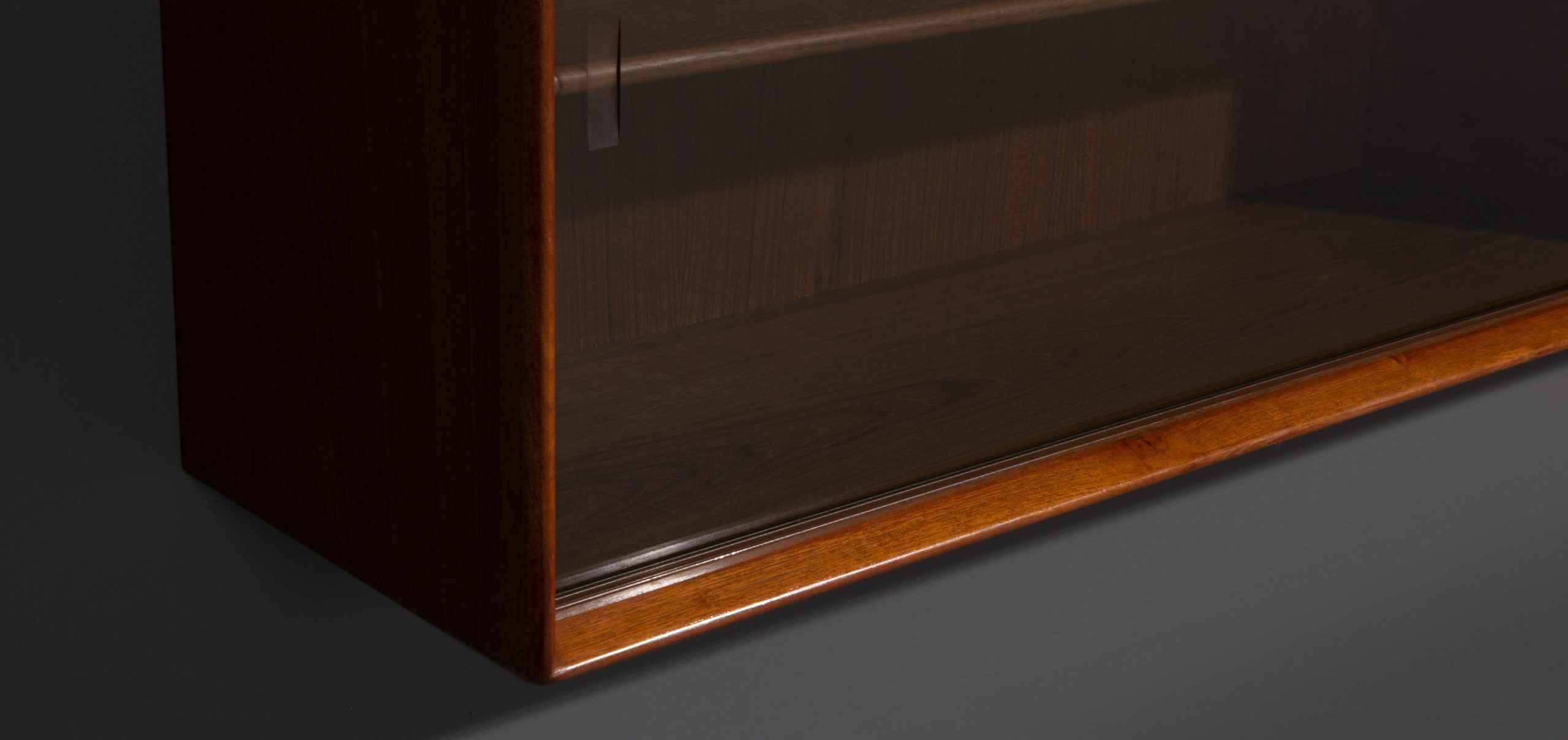 Teak wall cabinet with sliding glass doors