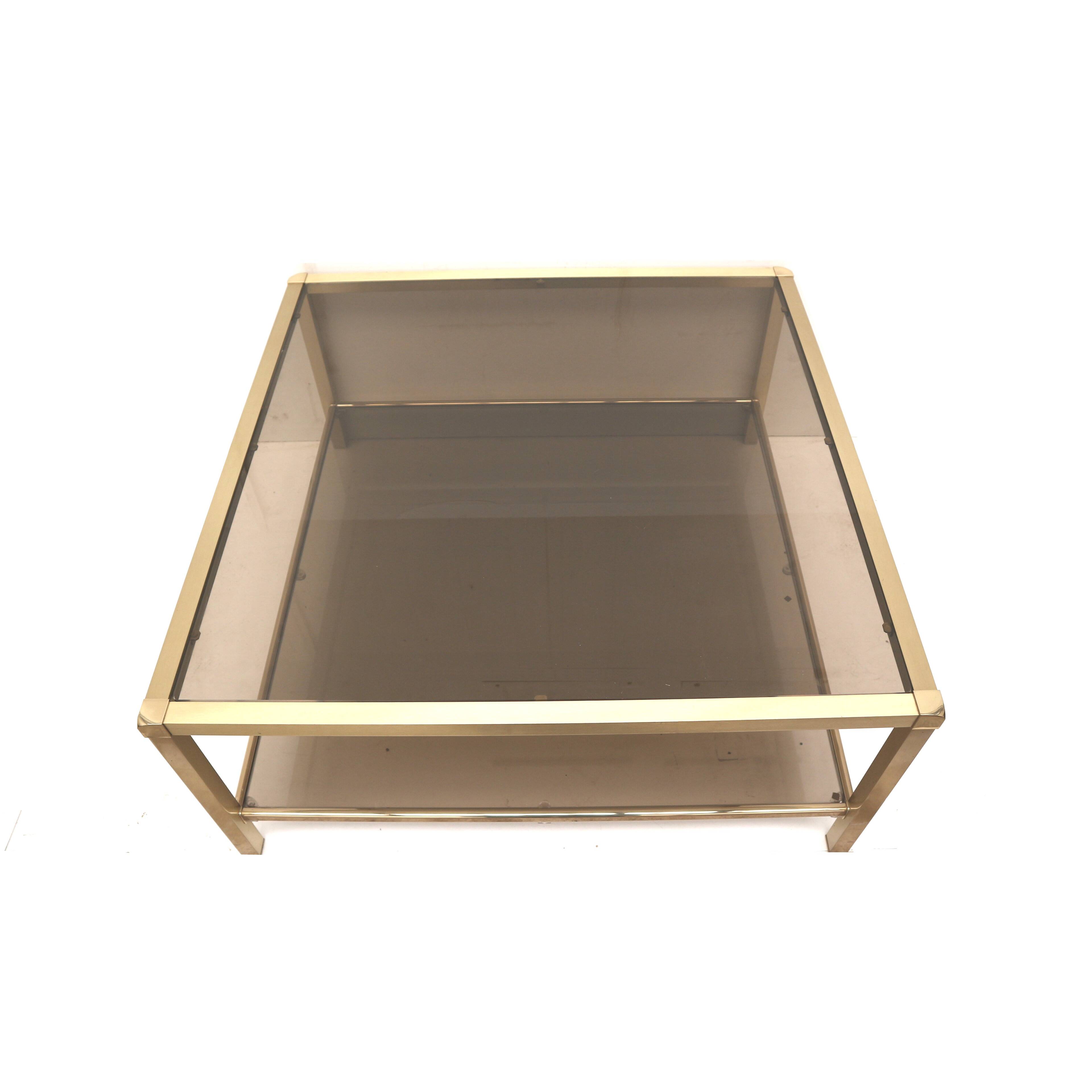 Large vintage Hollywood Regency coffee table made of brass and smoked glass from the 1970s