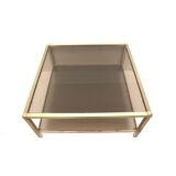 Large vintage Hollywood Regency coffee table made of brass and smoked glass from the 1970s