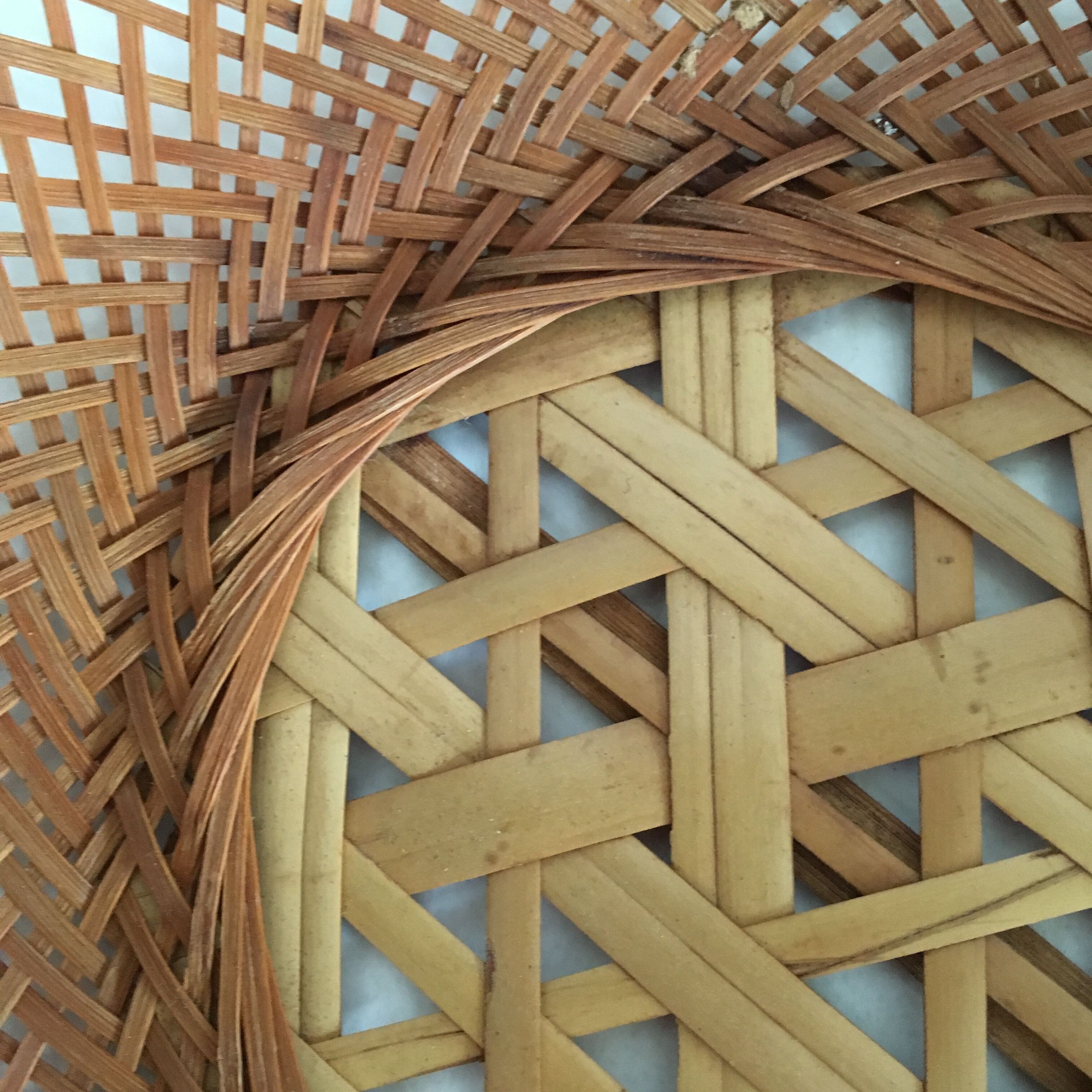 Braces of wood and woven rattan oval basket