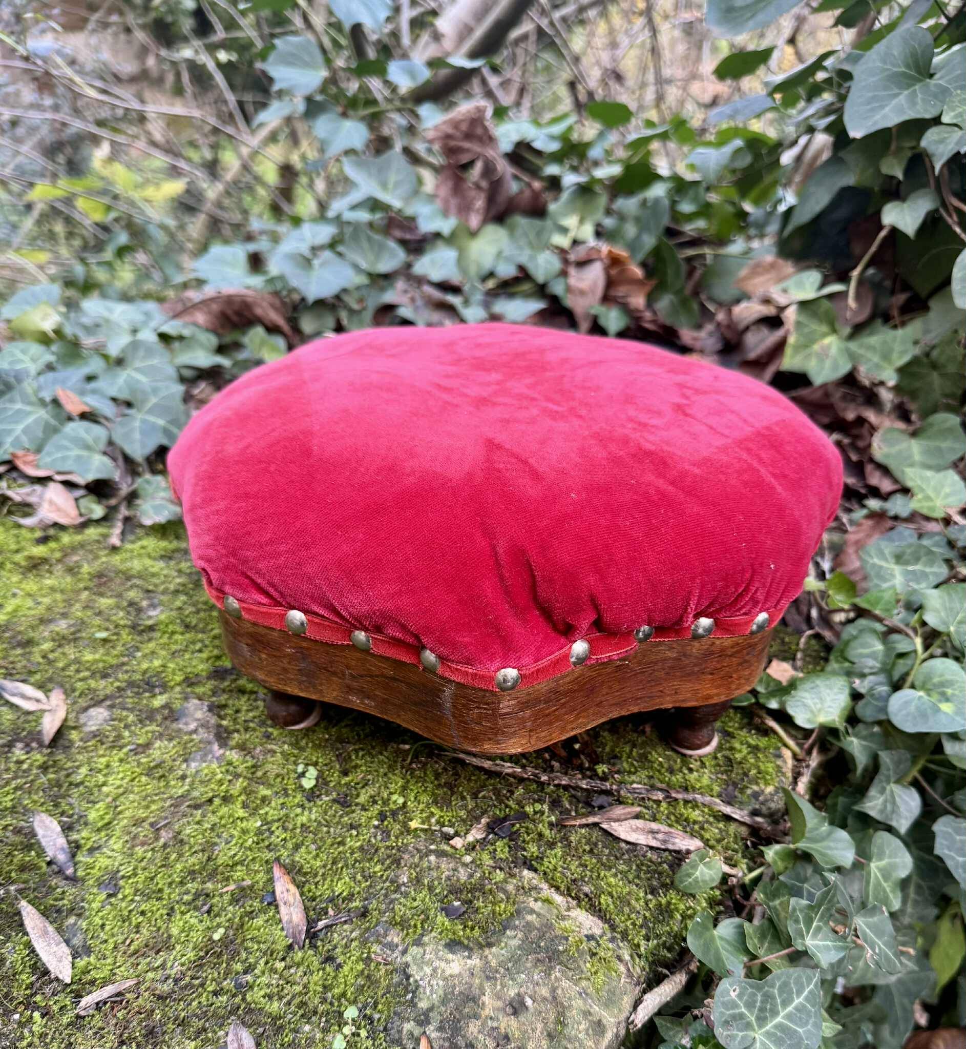 Red velvet footstool in the Louis XV style