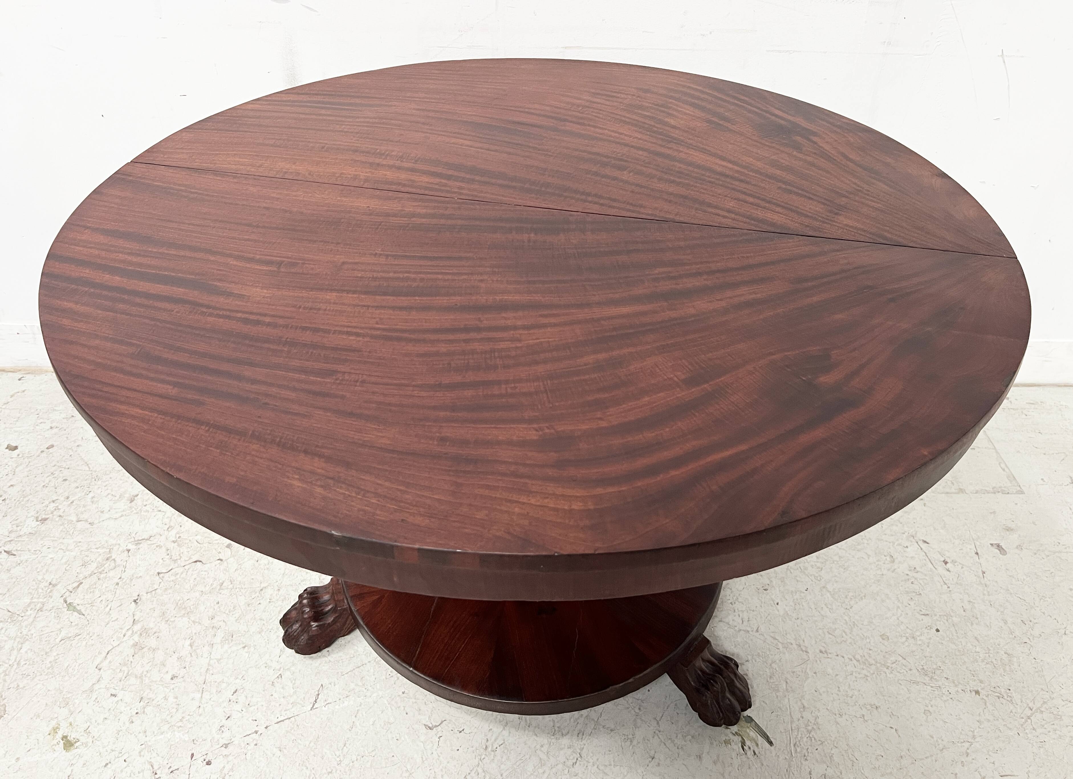 Empire style round table with claw feet, 19th century.