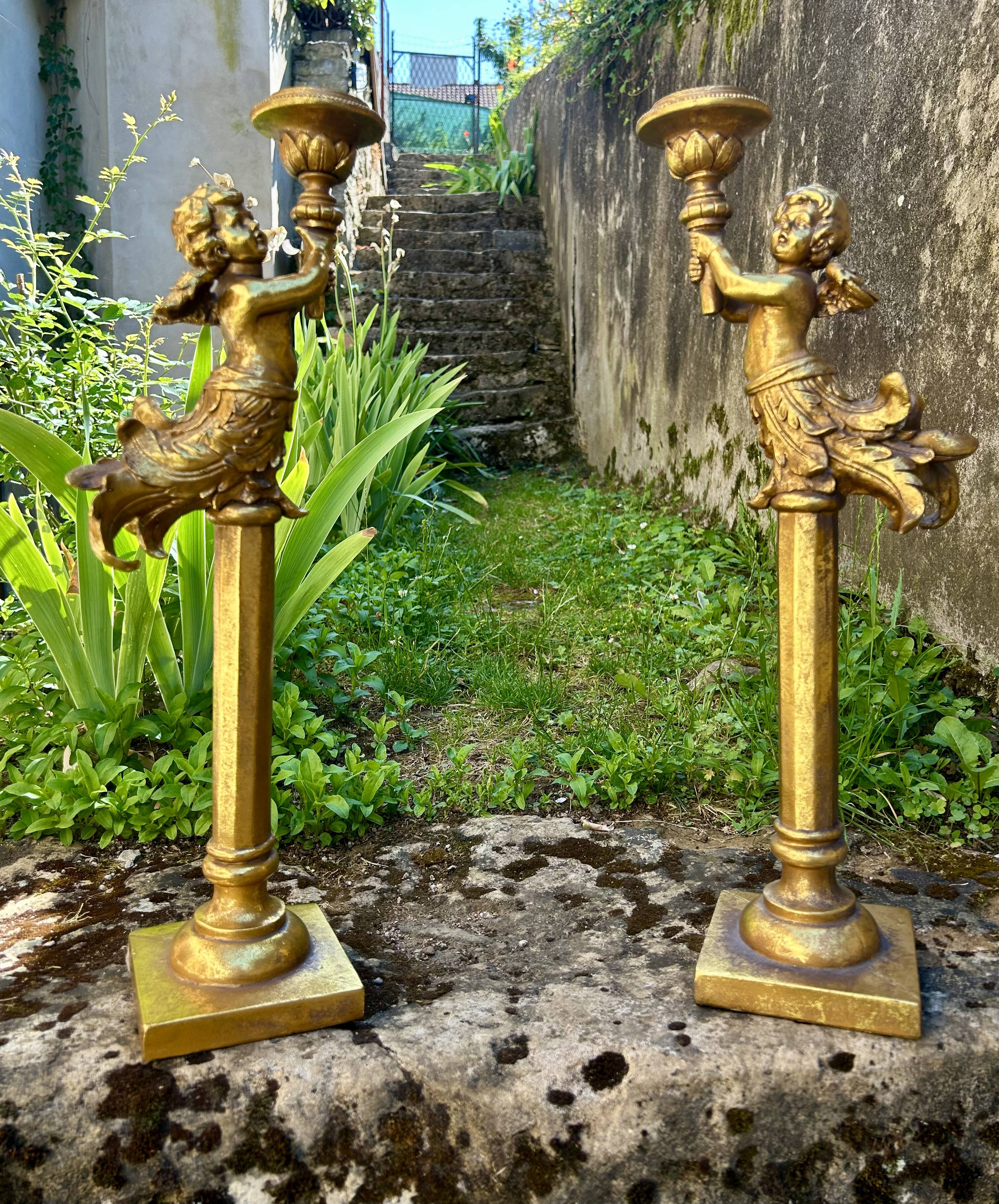 Pair of large candlesticks with cherubs
