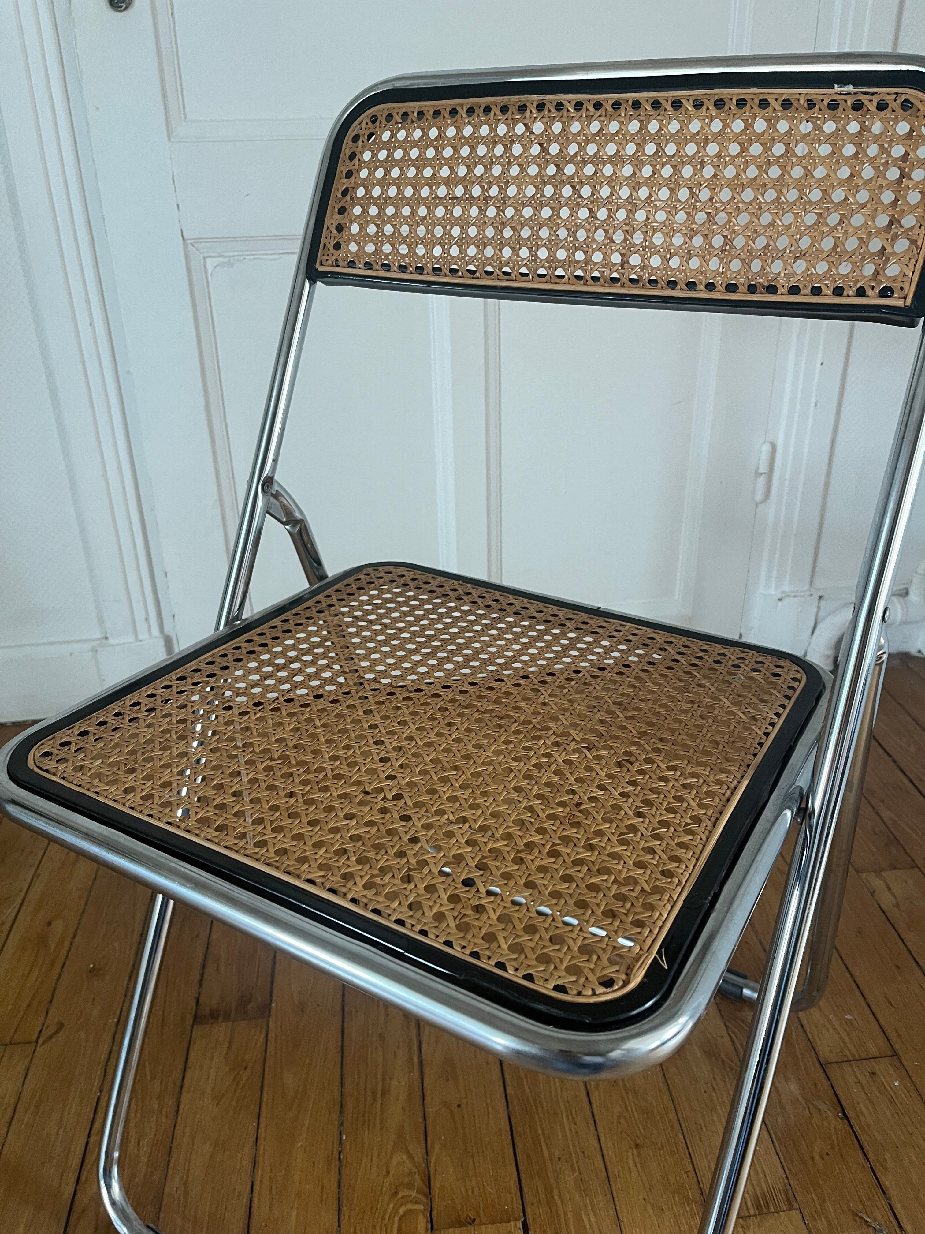 Vintage folding chair in metal and cane.