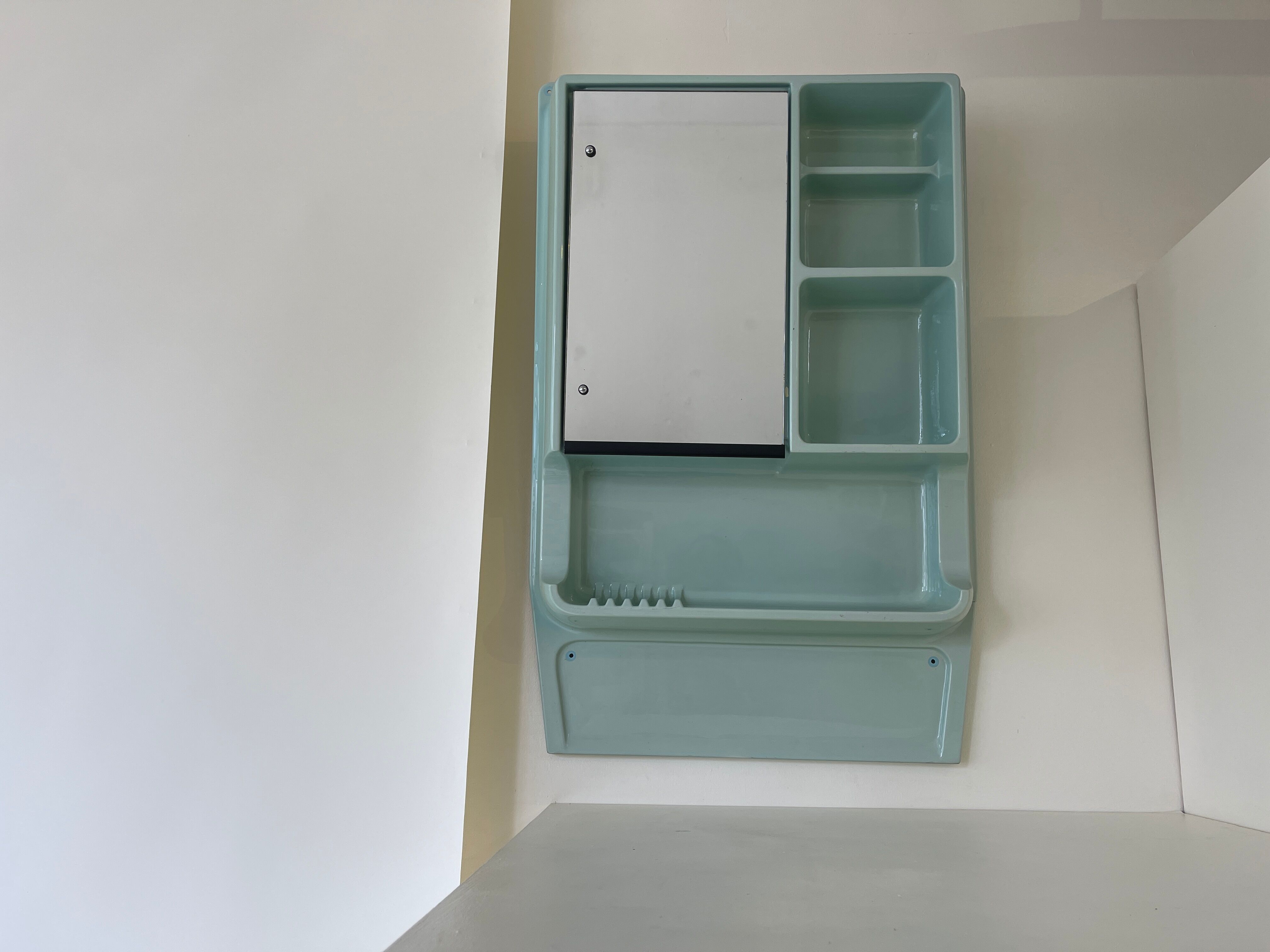 Baby blue plastic mirror and wash station