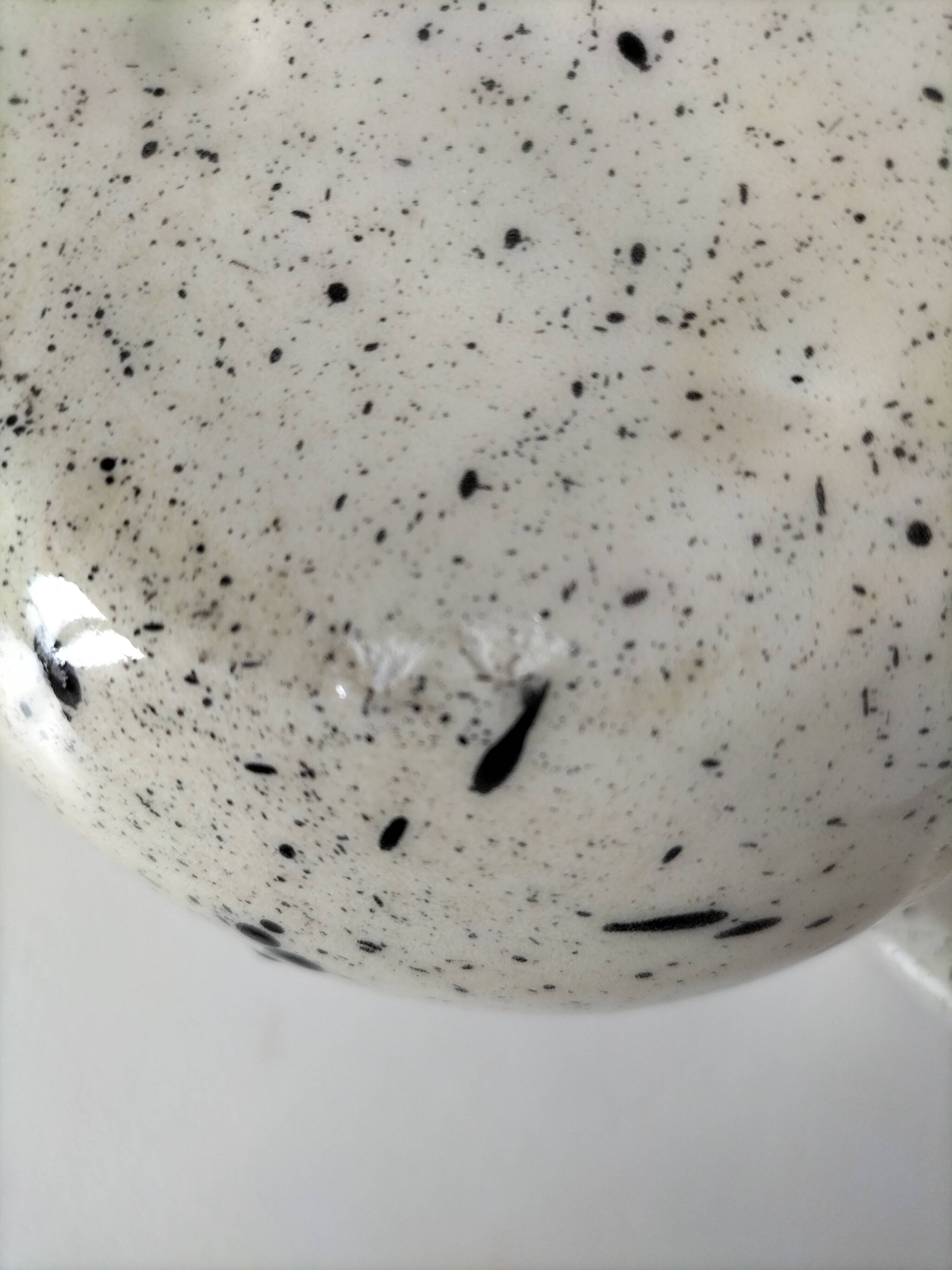 Small speckled ceramic jug in a vintage workshop style.