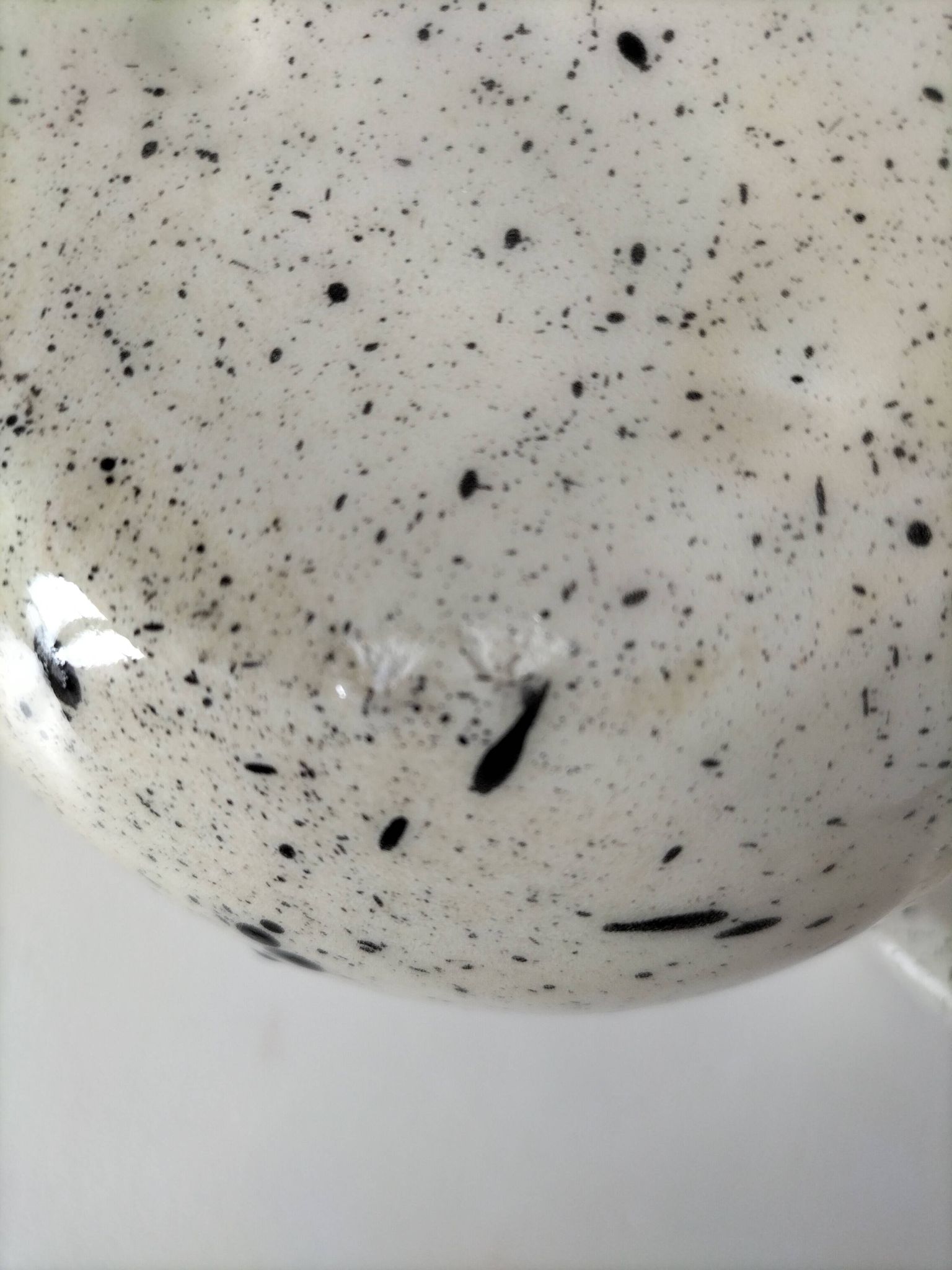 Small speckled ceramic jug in a vintage workshop style.