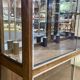 Early 20th-century shop display cabinet in oak with sliding doors.