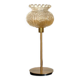 Table lamp with an antique crowned globe and a golden base