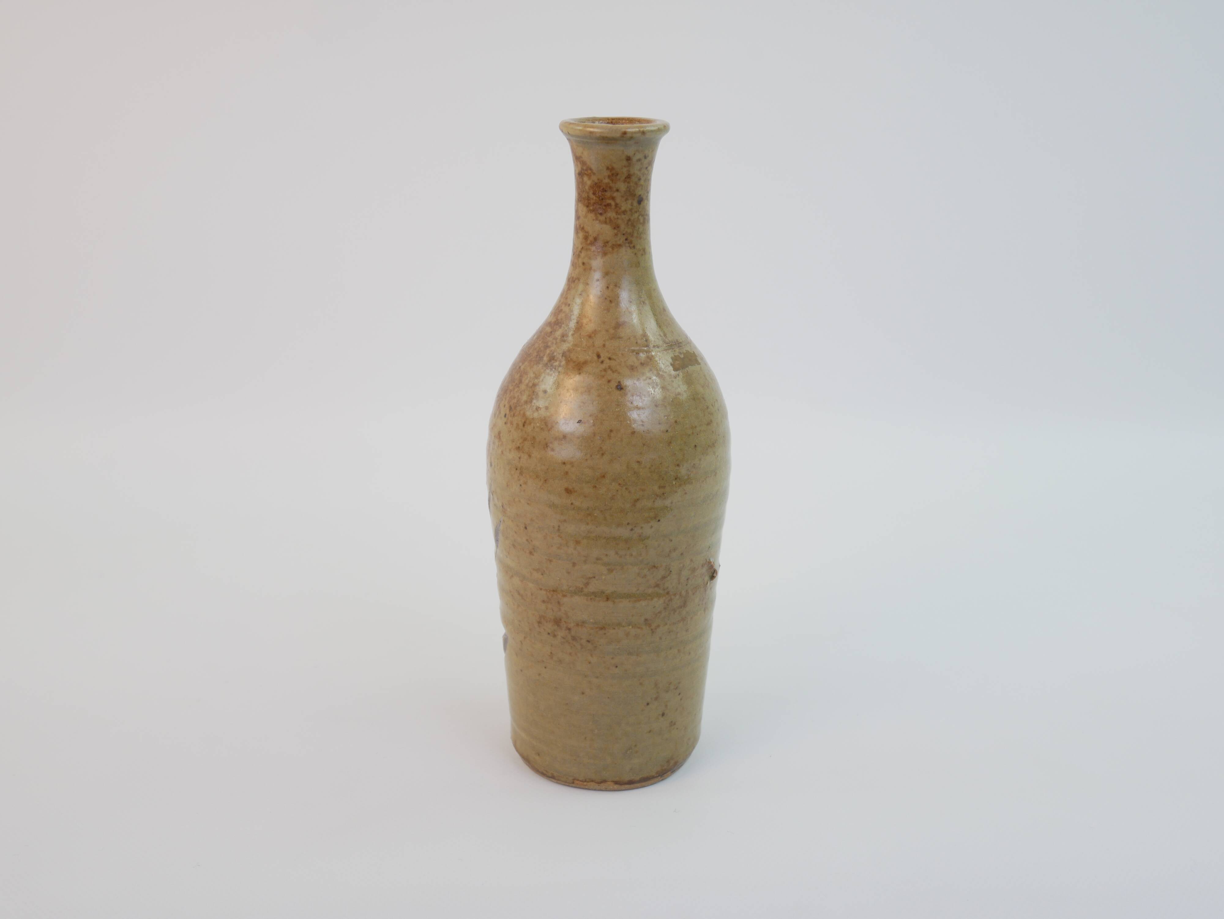 Brown ceramic/stoneware bottle with chiseled floral pattern
