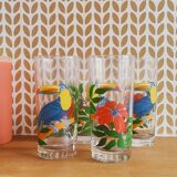 Vintage lemonade glasses with tropical parrot and flower patterns.