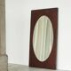 Faceted oval mirror with rectangular oak frame from the 1920s.