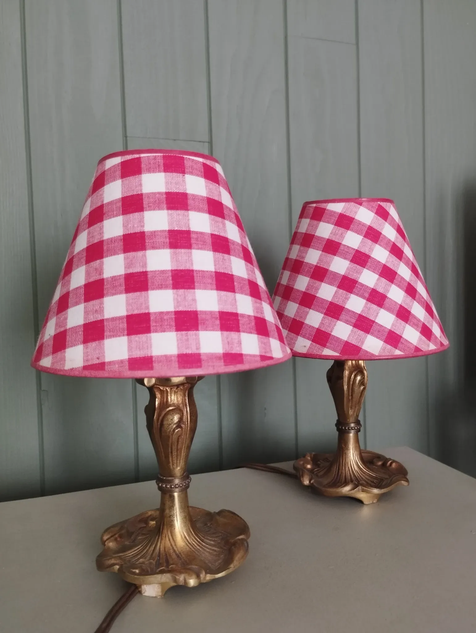 Pair of small lamps in gilded bronze by Petitot and red gingham lampshades.