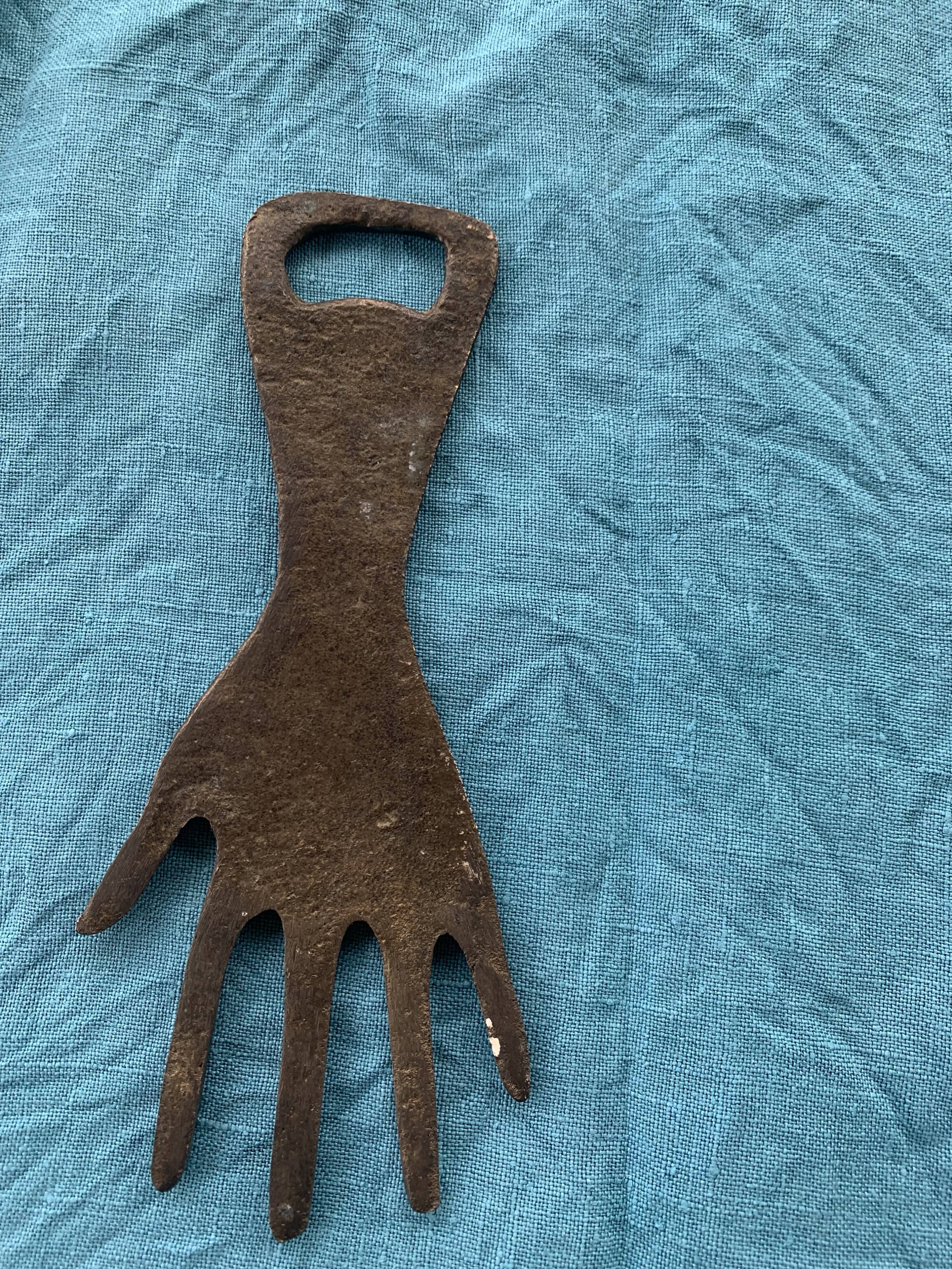 Two brass bottle openers in the shape of a chiseled hand vintage oriental décor