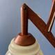 Vintage wall lamp with teak wood scissors and glass shade.