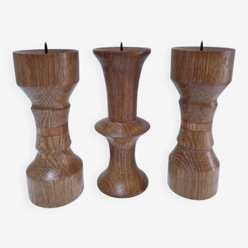 Three vintage patinated solid wood candlesticks