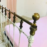 Old white metal and brass bed