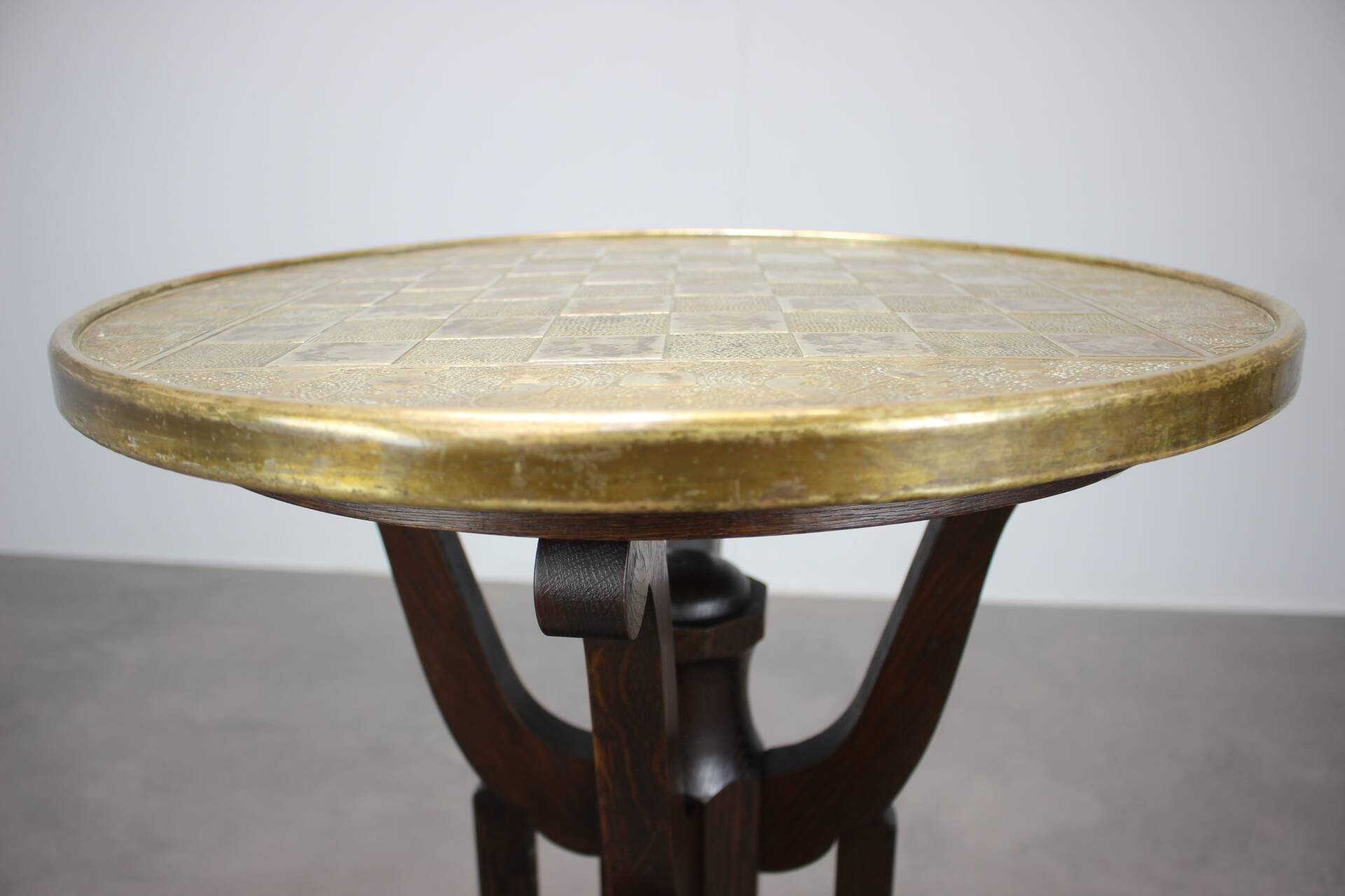 Art Deco chess table from the 1930s with a hand-decorated brass top and a stained oak base.