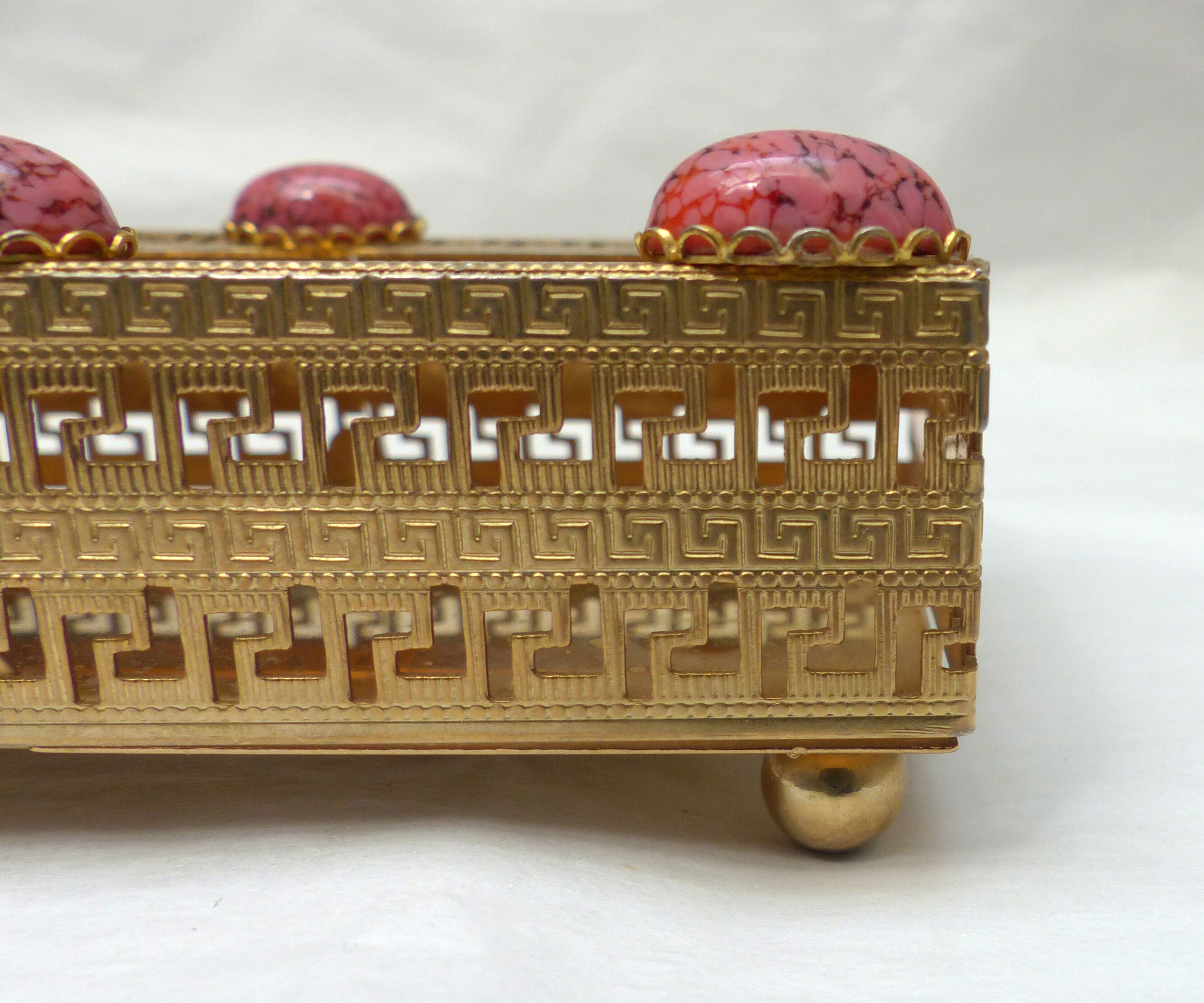 Golden metal catchall with pink stones