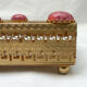 Golden metal catchall with pink stones
