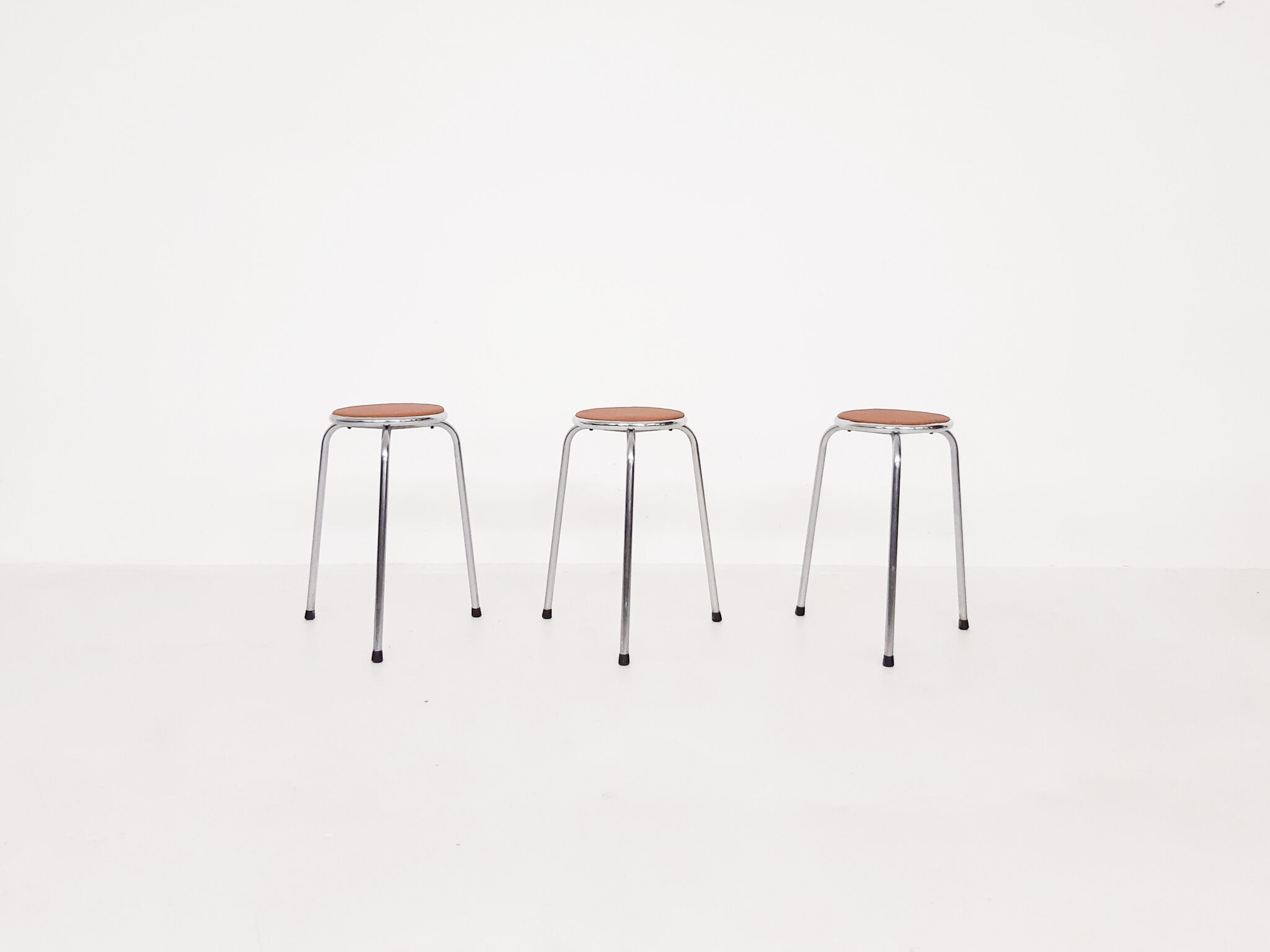 Set of 3 chrome stools with cognac leather seating, 1960's