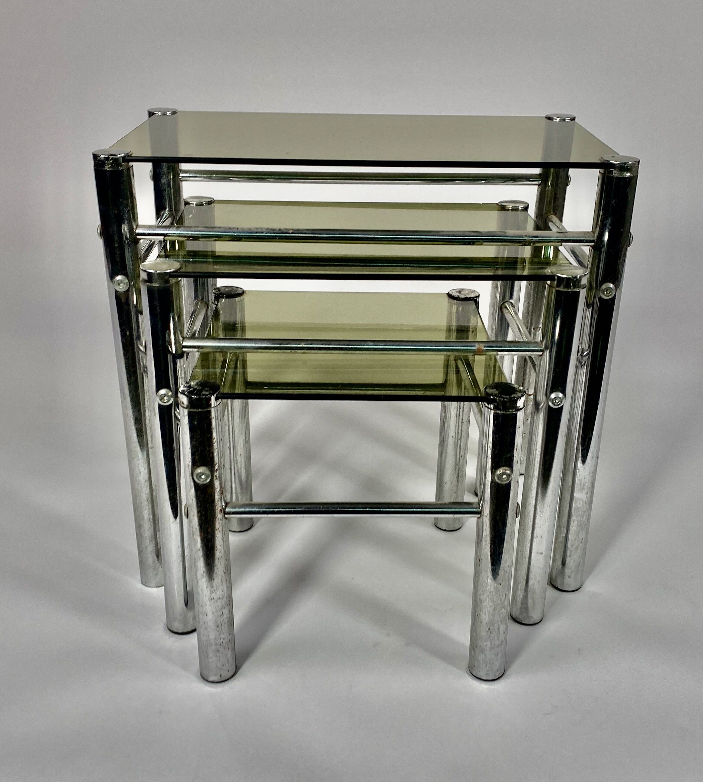 Tables in chrome metal and tinted glass. year 70