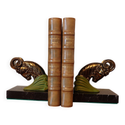 Art Deco pair of bookends with ram's heads, patinated metal and black marble.