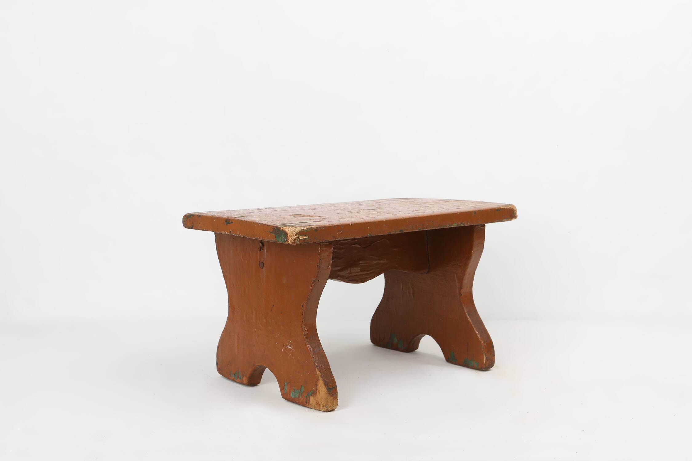 French rustic low church stool in terracotta painted wood, ca. 1900