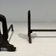 Pair of Modernist Andirons in Cast Iron with Openwork Uprights and Tripod Bases
