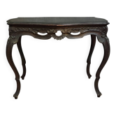 Antique desk in the Louis XV style, resting on four curved legs.