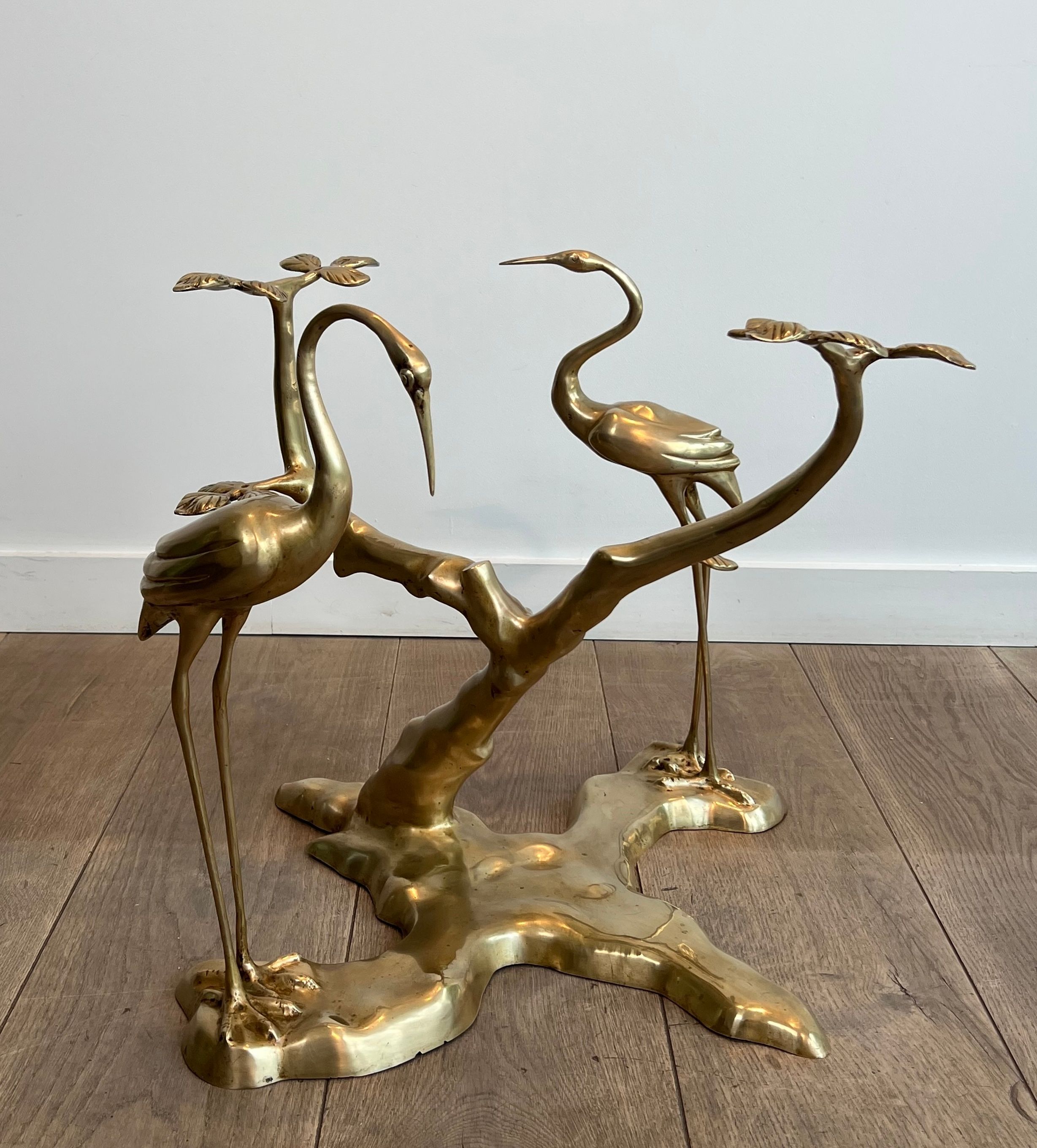 Coffee table model with cranes surrounding a brass bonsai and round glass top by Willy Daro.