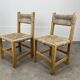 2 straw and wood chairs in brutalist style