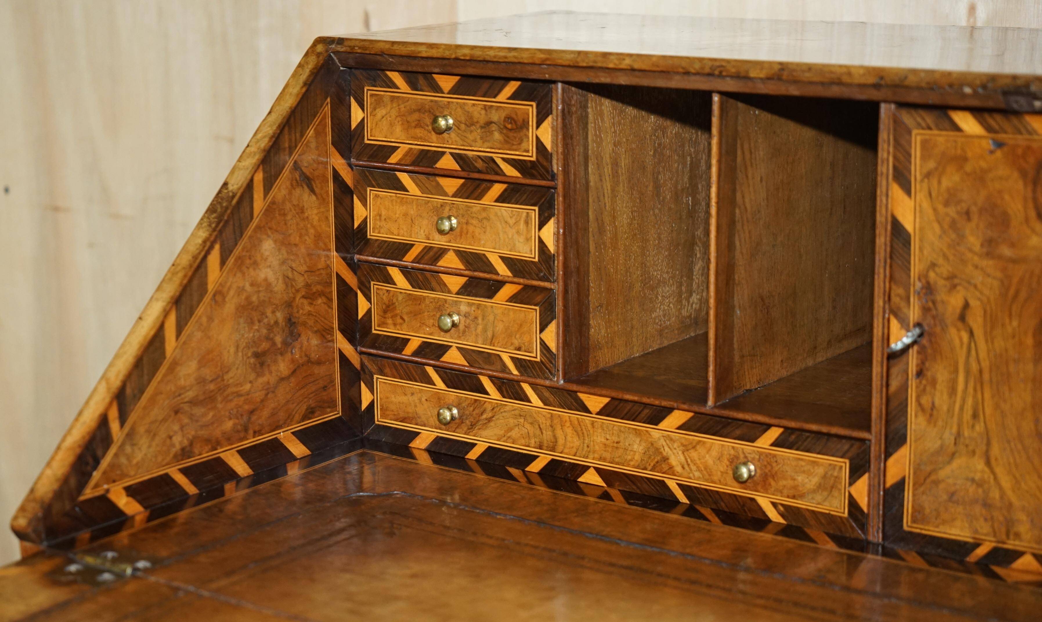 Antique George II bureau from 1740 in walnut, rosewood, and leather.