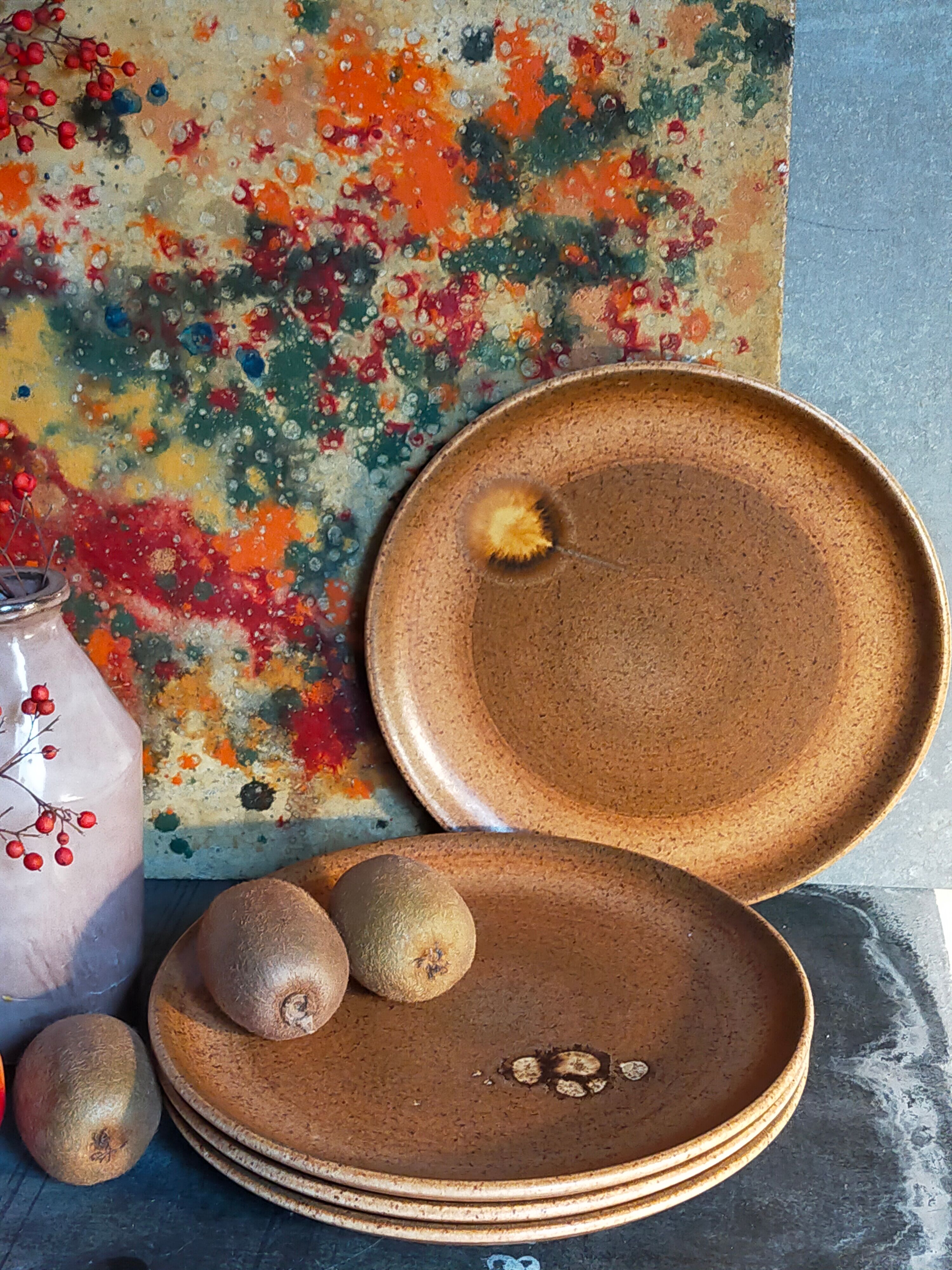 Four vintage glazed stoneware potter's plates