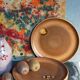 Four vintage glazed stoneware potter's plates
