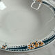 Longwy salad bowl with blue and orange floral decoration.