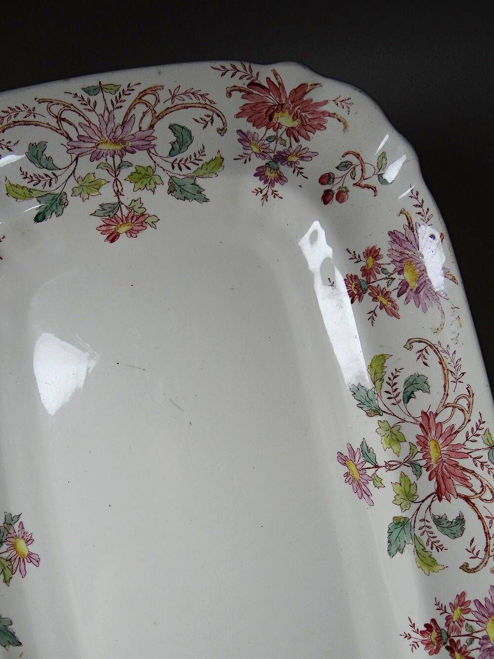 Antique Longchamp serving platter with polychrome daisies in ironstone.