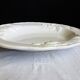 Oval white vegetable dish, an antique tableware piece in barbotine earthenware.