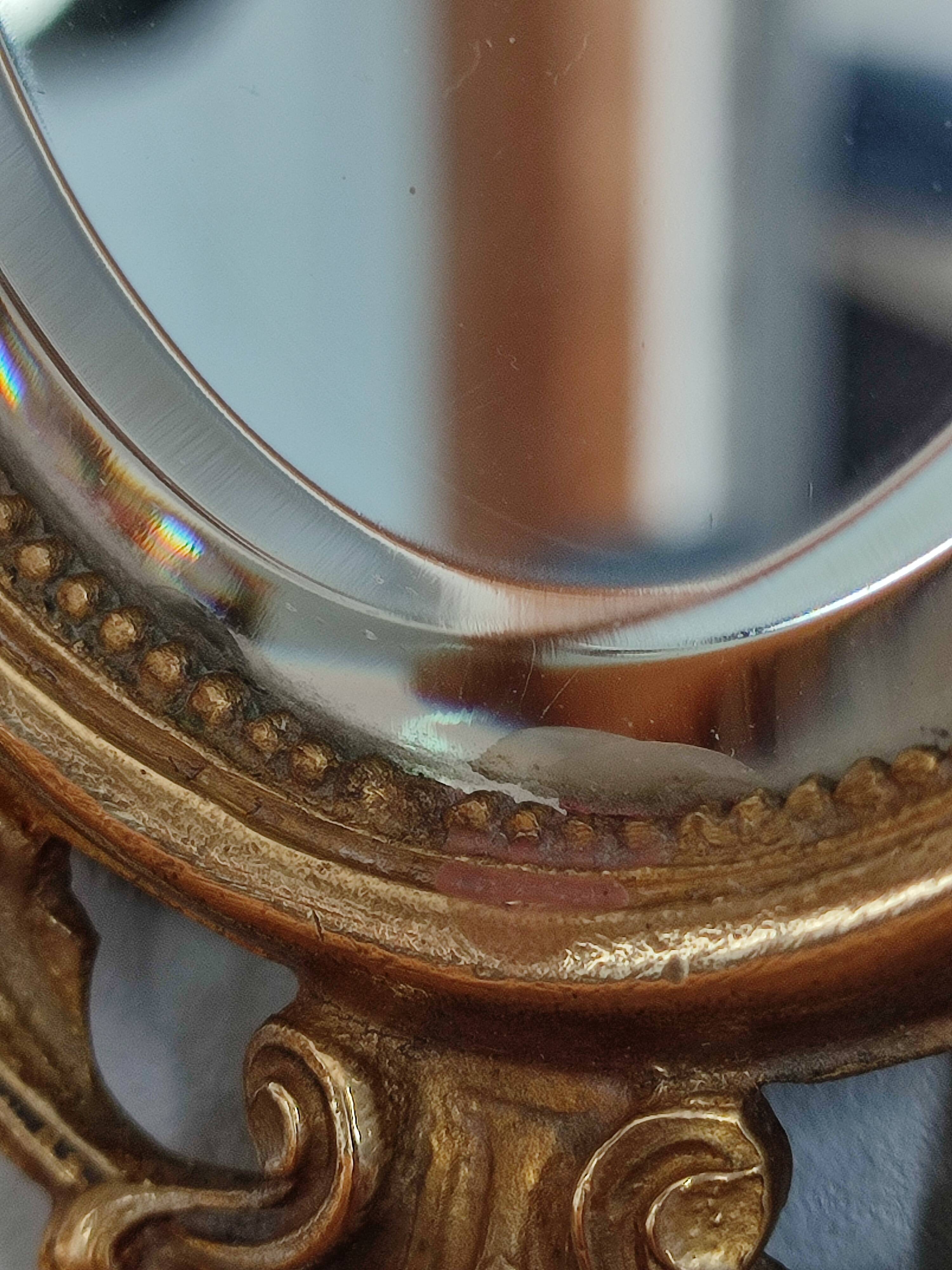 Antique hand-facing mirror in bronze and beveled glass