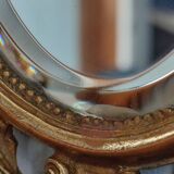 Antique hand-facing mirror in bronze and beveled glass